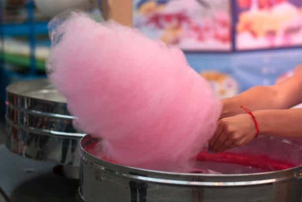 Cotton candy being spun in a candy floss machine