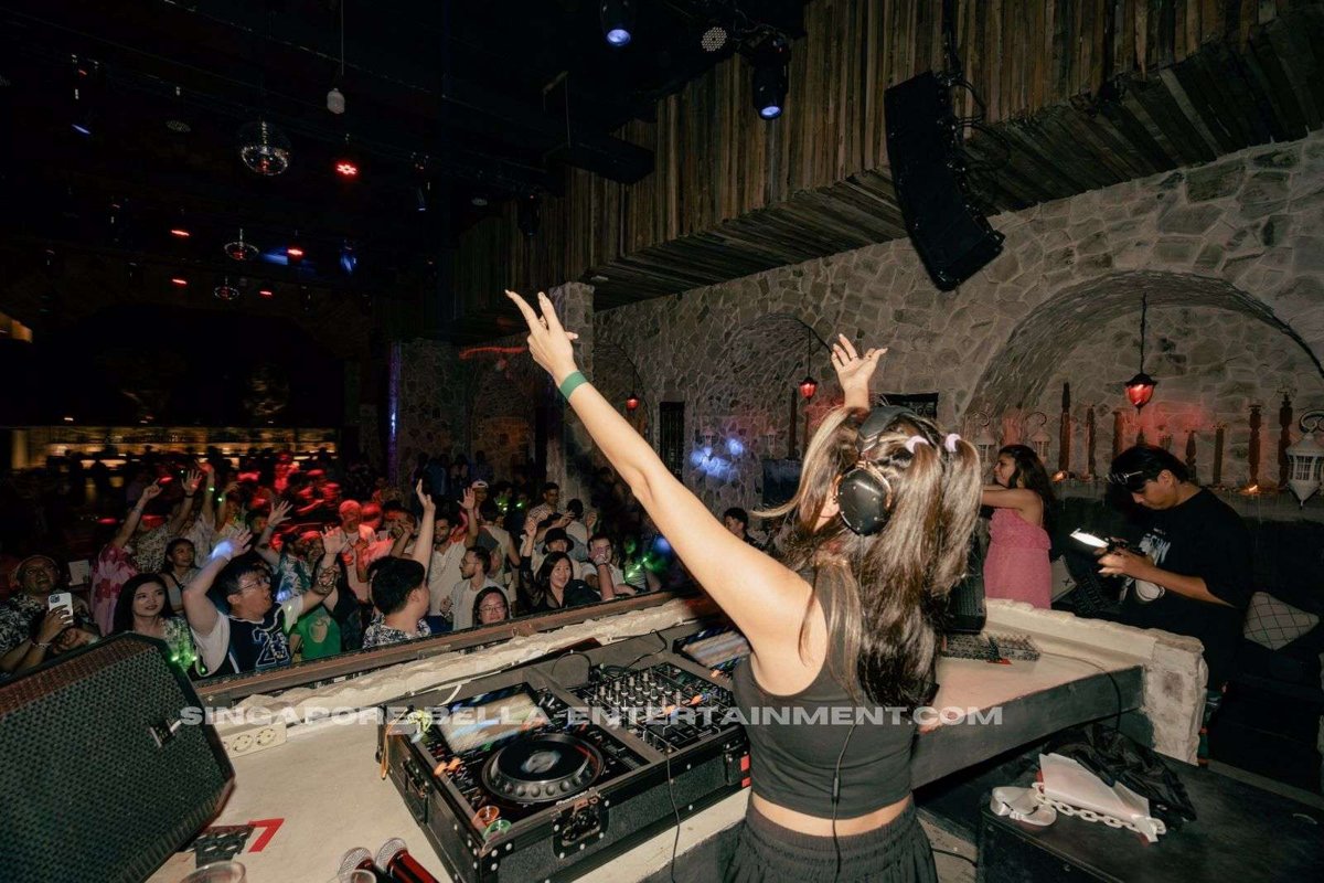 Female DJ hyping a crowd in Singapore