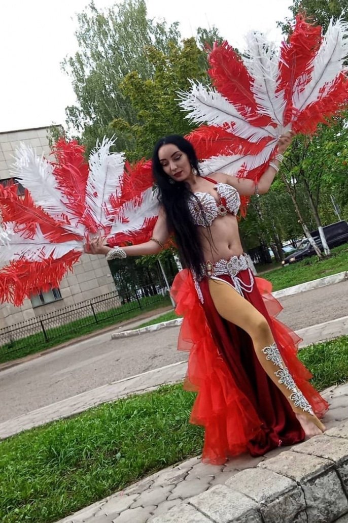 Belly dancer with red feather fans in Singapore
