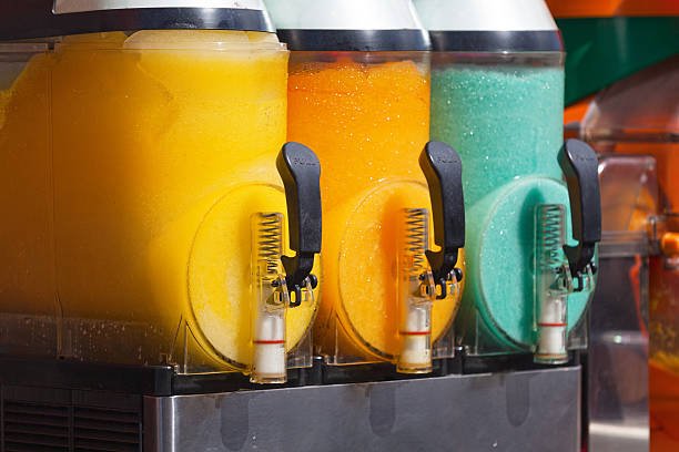 Slushie machine with orange, yellow and green flavours
